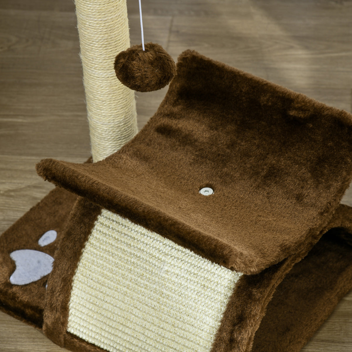 Close-up of brown plush cat tree perch, sisal tunnel, scratching post, and dangling ball