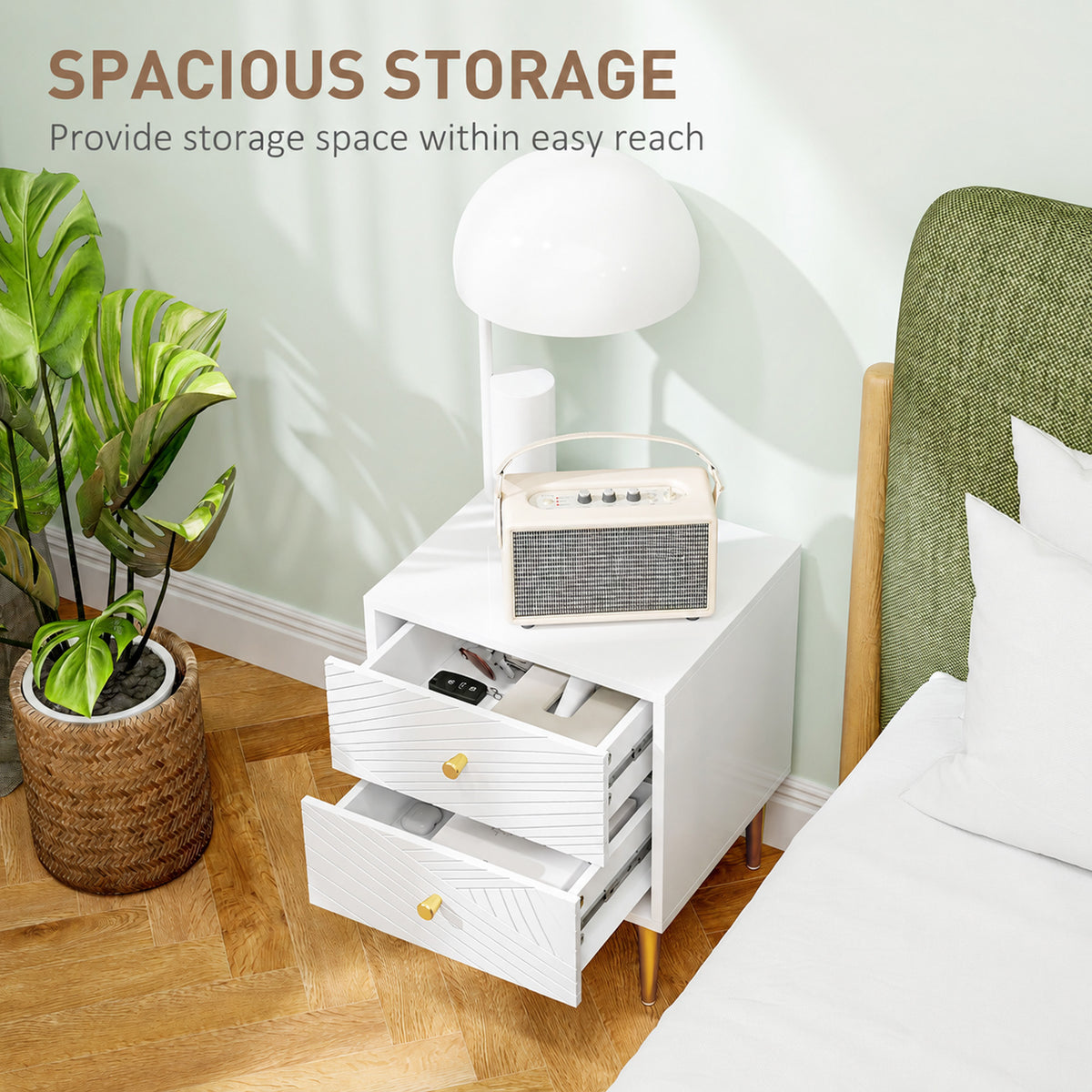 White bedside table with two open drawers showing storage space and gold-tone knobs