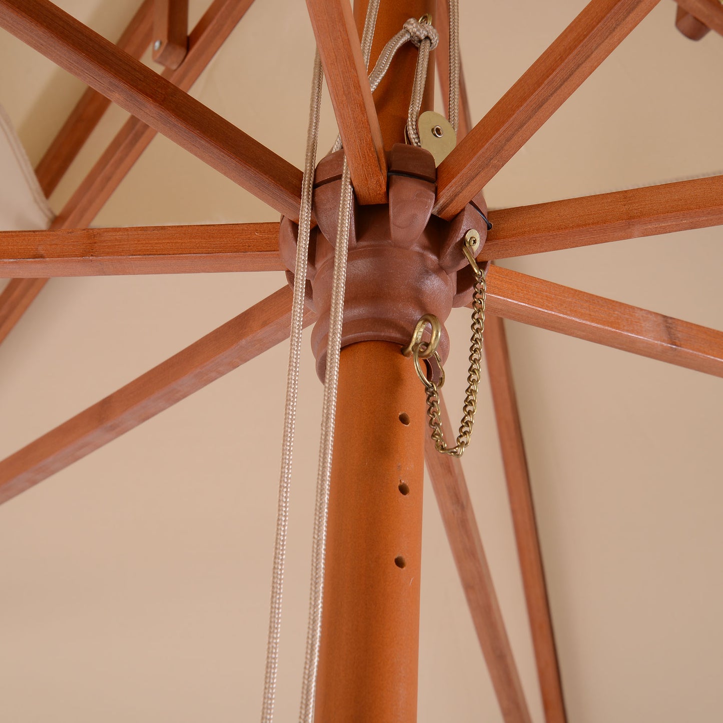 Close-up of wooden parasol pole, canopy ribs, pulley rope and angle latch