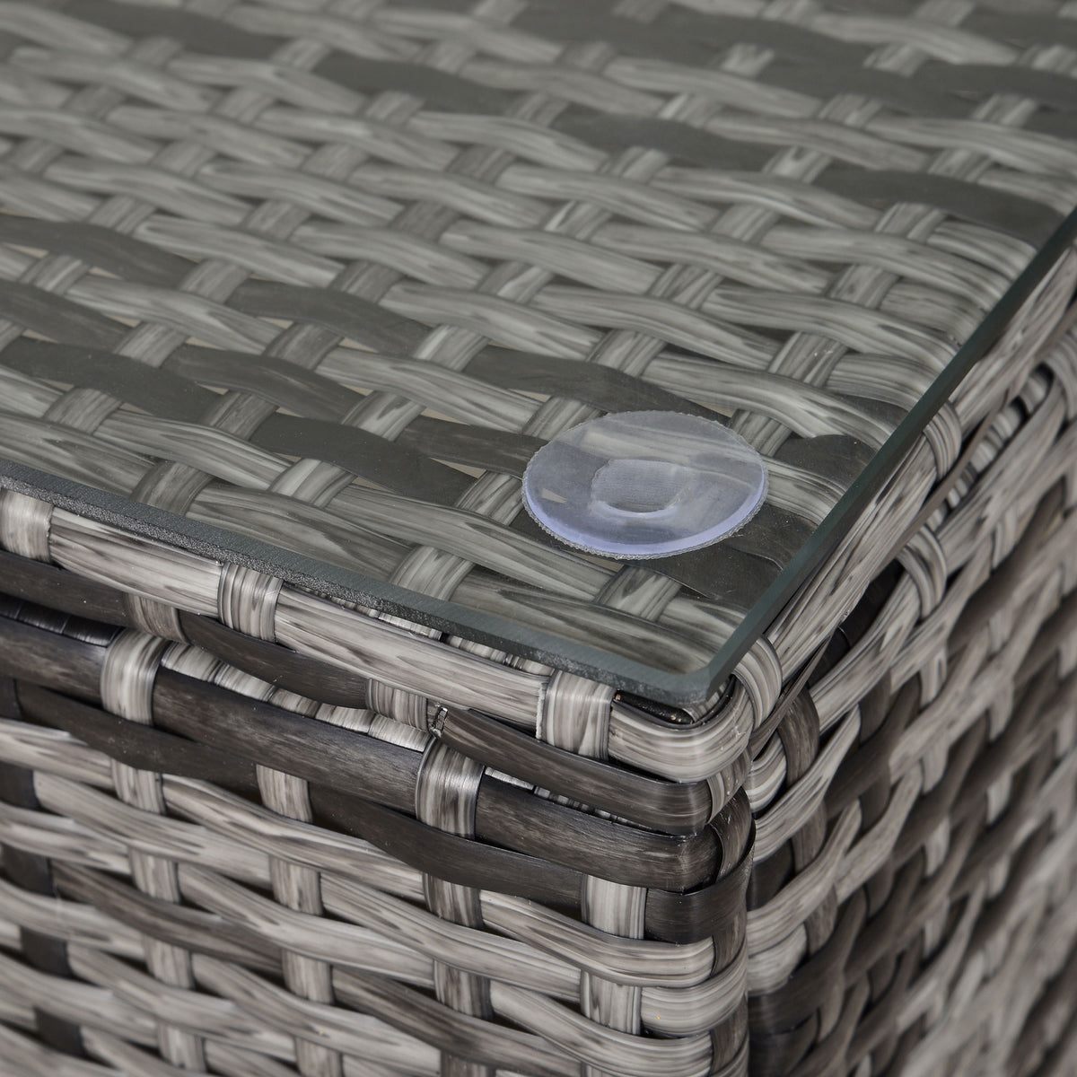 Outsunny coffee table corner detail showing glass top and grey woven rattan edging