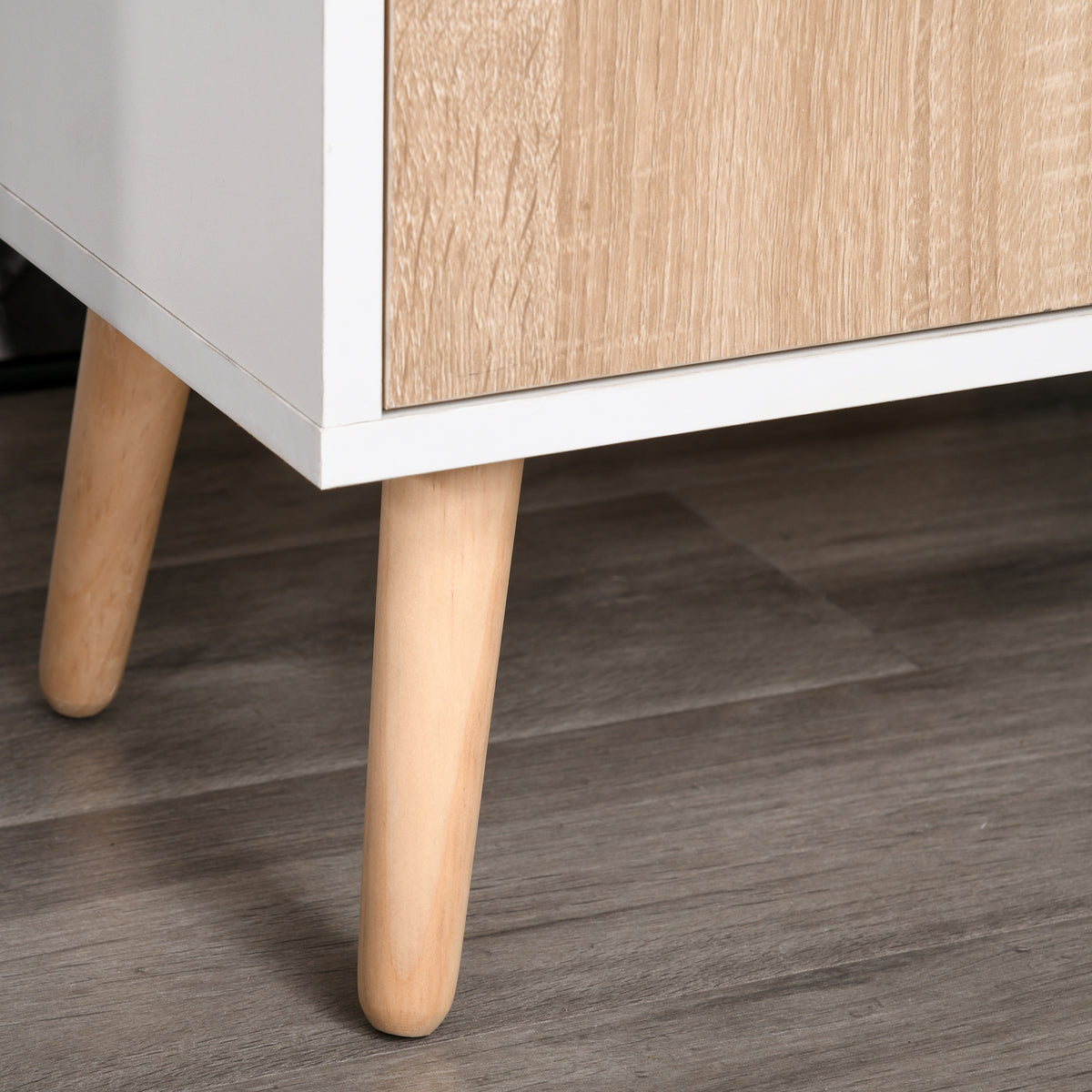 Close-up of the sideboard's tapered natural wood leg and wood-look door