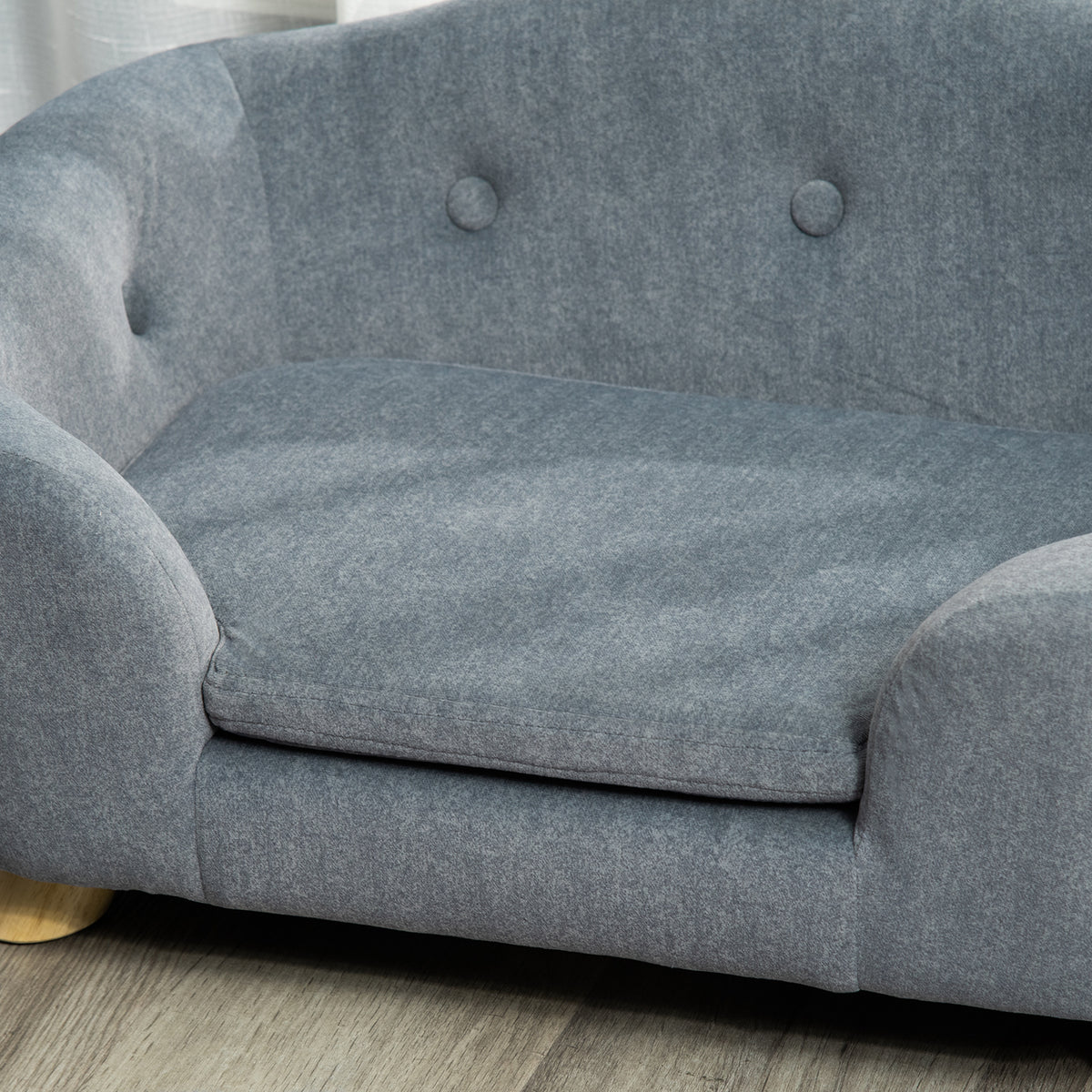 Close-up of PawHut sofa's grey fabric cushion and buttoned back