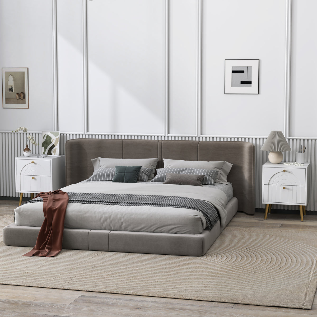 White two-drawer bedside table with arched fronts and gold accents beside a bed
