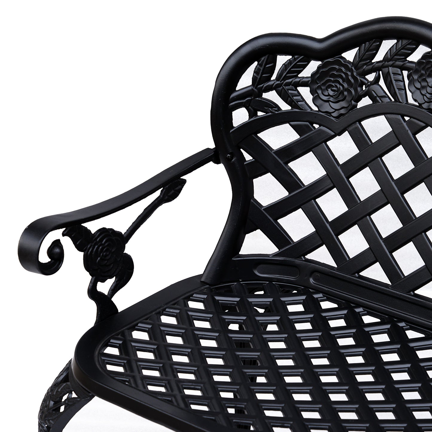 Close-up of the black bench's lattice seat, floral back, and curled armrest