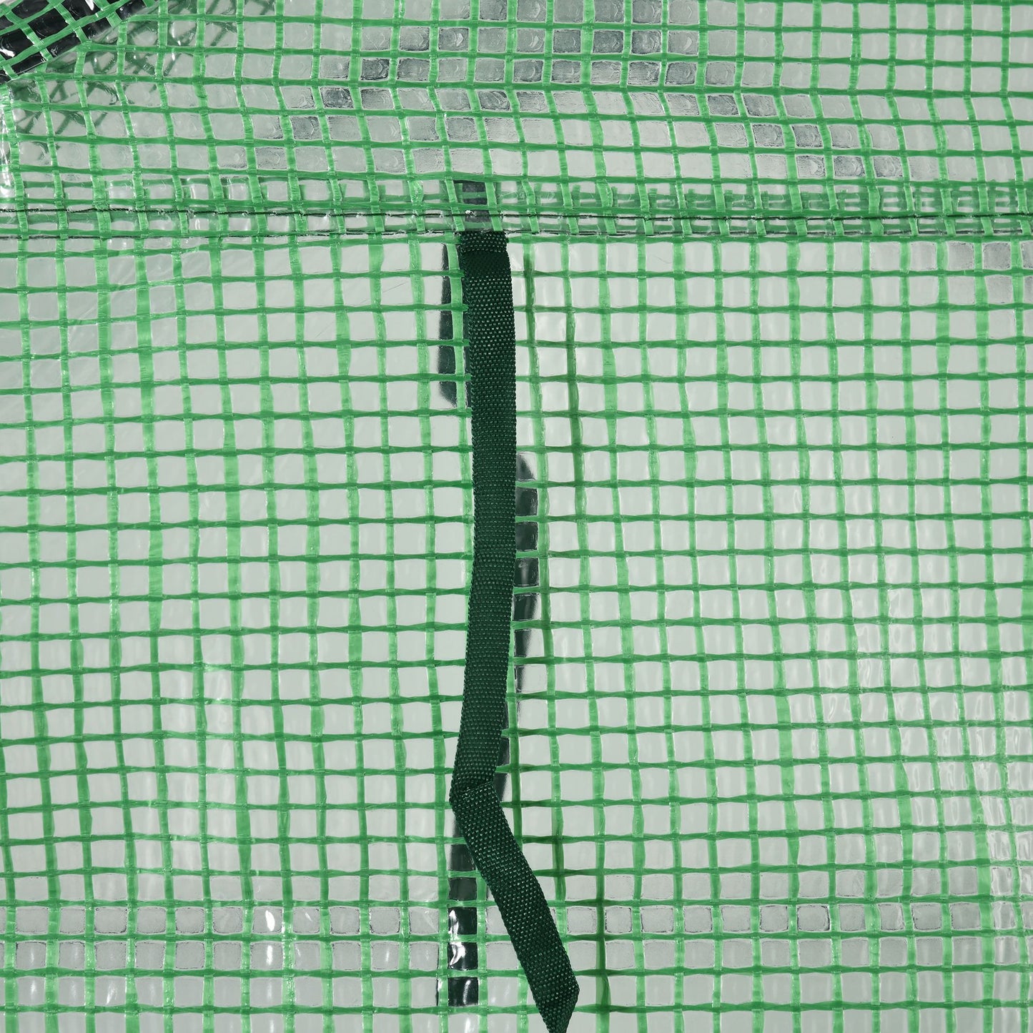 Close-up of green greenhouse mesh cover and black fastening strap