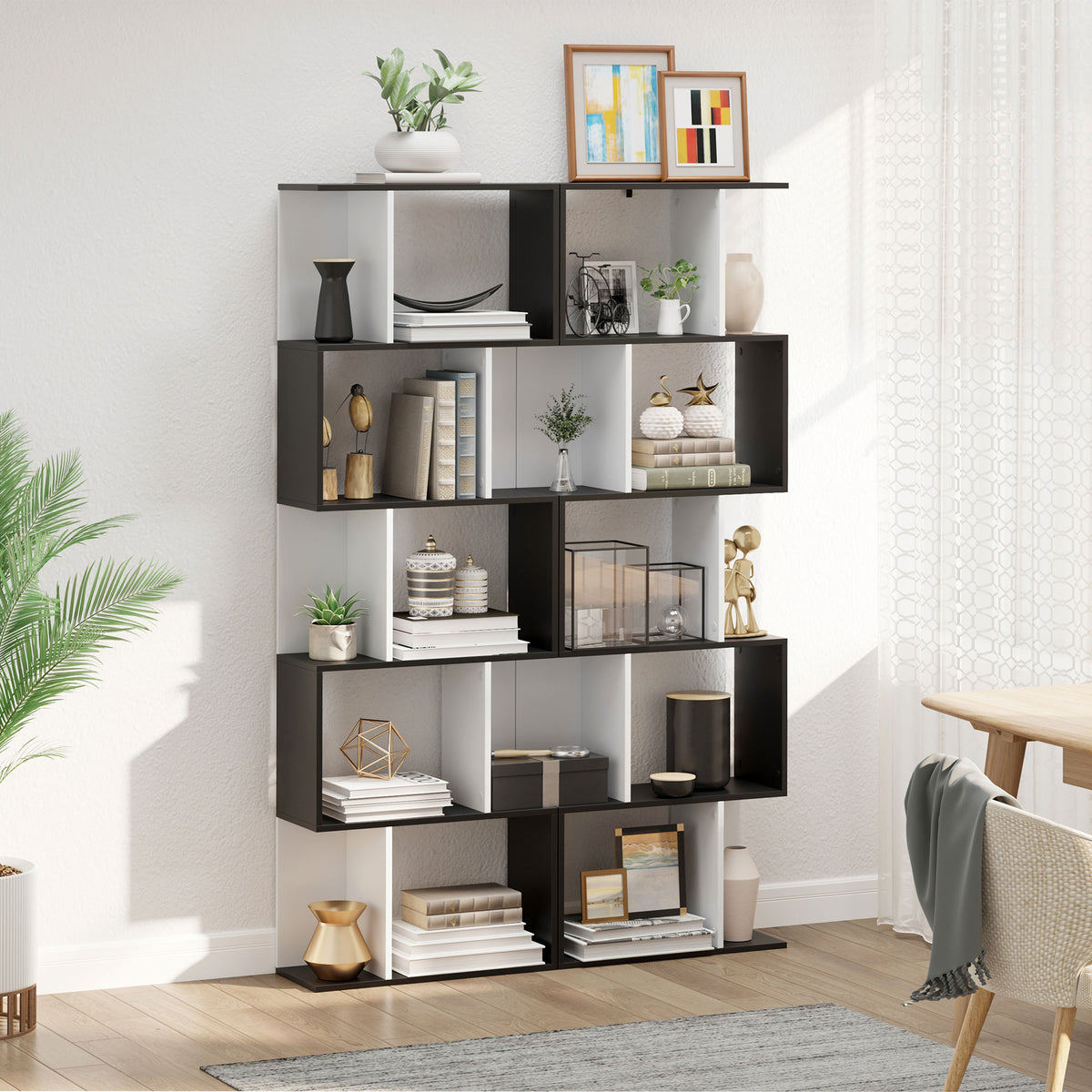 Black and white five-tier S-shaped bookcase with books and decorative items