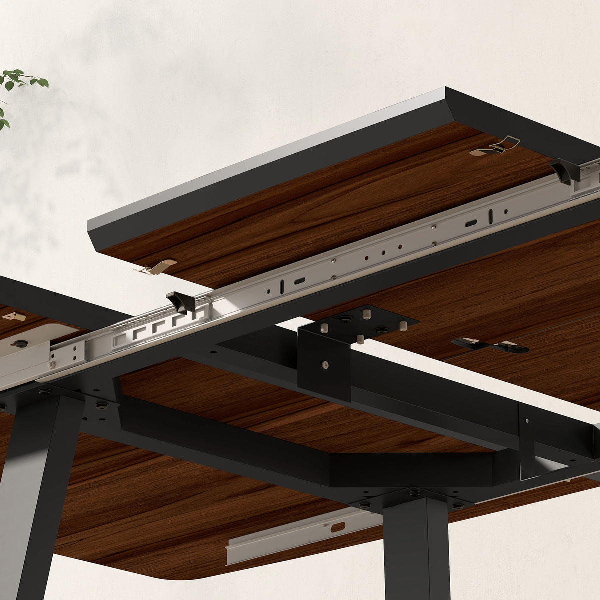 Underside of extendable dining table showing sliding leaf mechanism