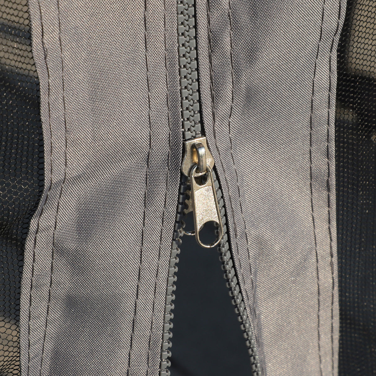 Gazebo curtain close-up showing a zipper and mesh side panel