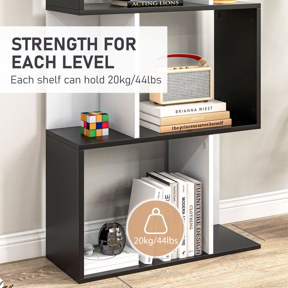 Close-up of black and white bookshelf compartments displaying books and decor
