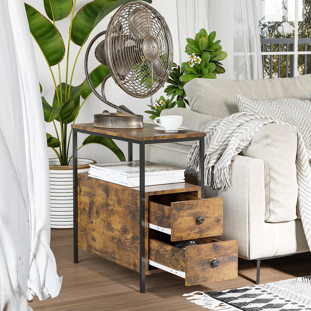 Side table beside an armchair, with two open drawers and a shelf holding books