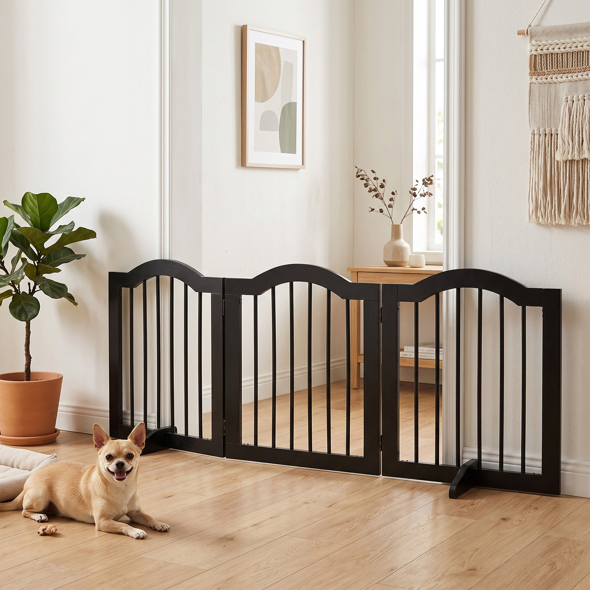 Black three-panel wooden dog gate set up across a room