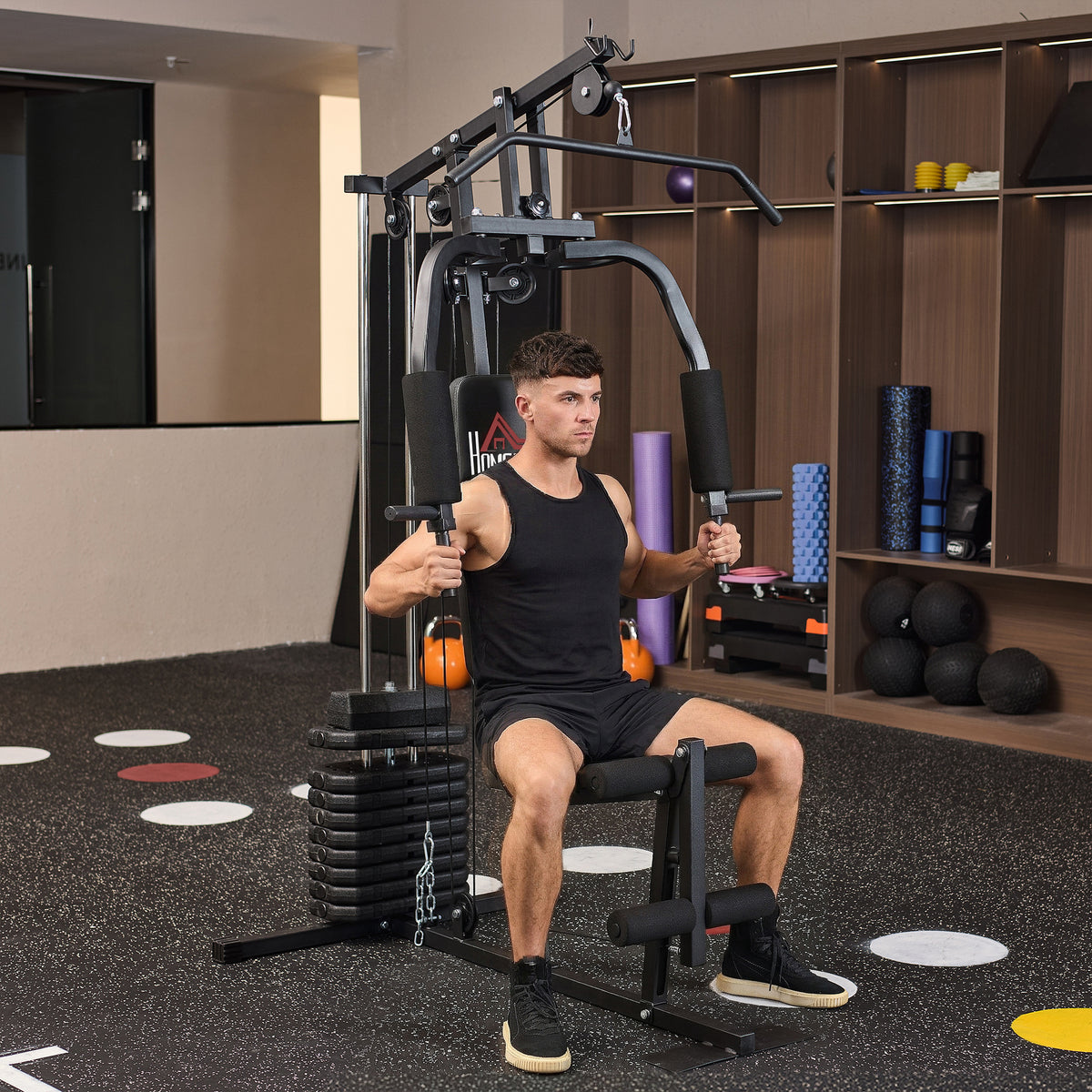 HOMCOM home gym machine with seated chest press arms and padded leg rollers