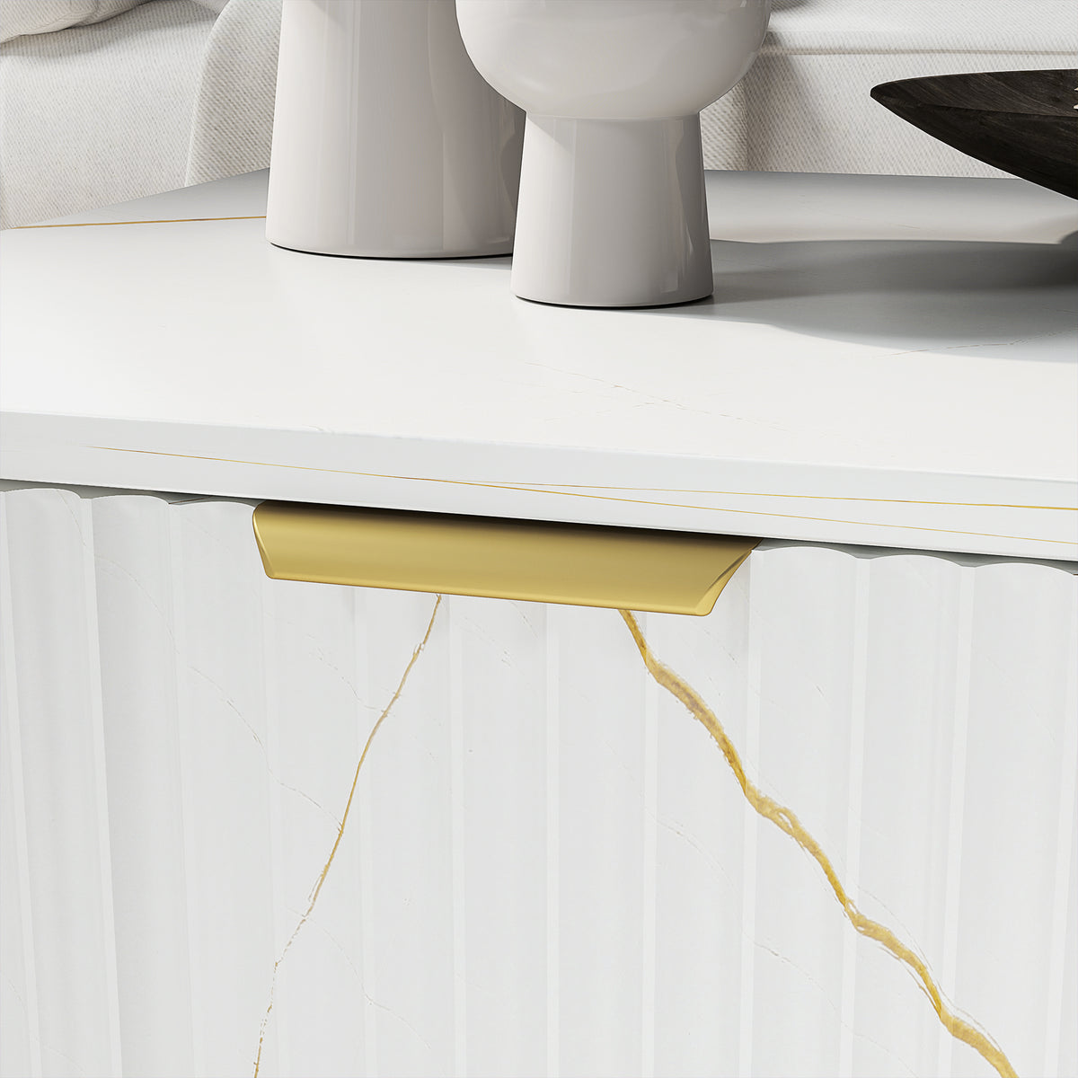 Close-up of the coffee table's fluted drawer front, gold-tone handle, and marble-effect finish