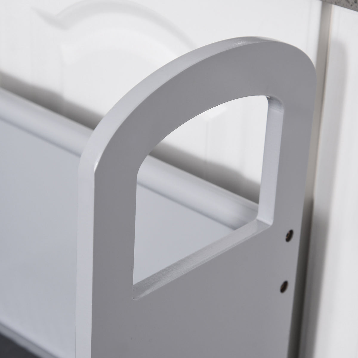 Close-up of the step stool's raised side handle and cutout grip