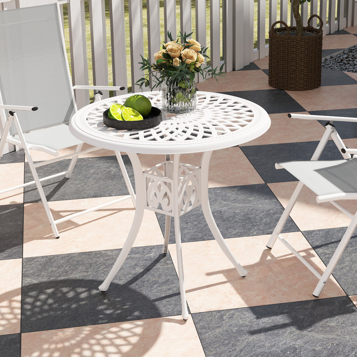 White round outdoor dining table with a patterned openwork top and curved legs