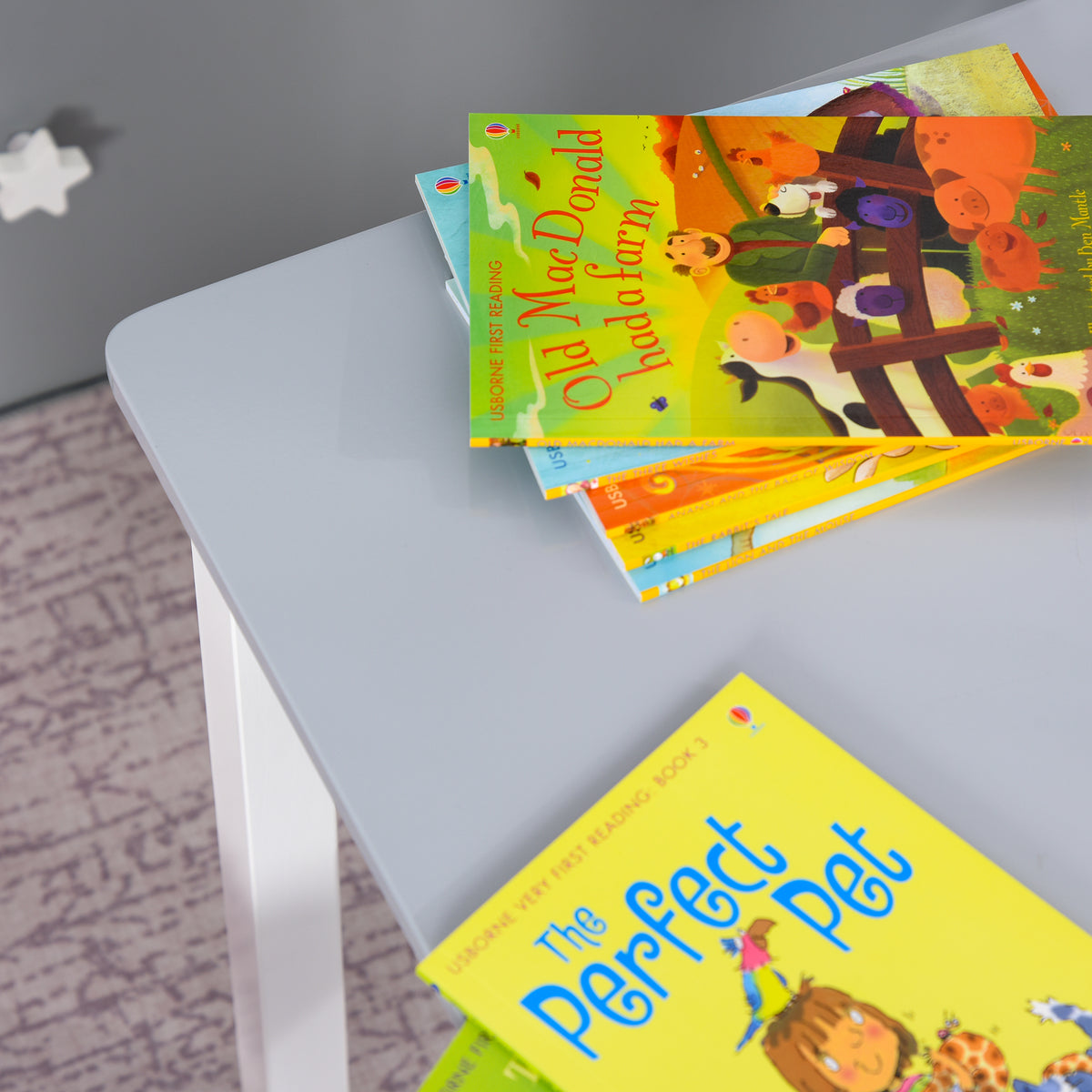 Gray kids' table with smooth tabletop displaying children's books