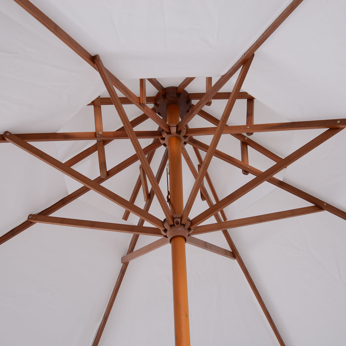 Close-up of the parasol's wooden frame, center pole, and canopy ribs