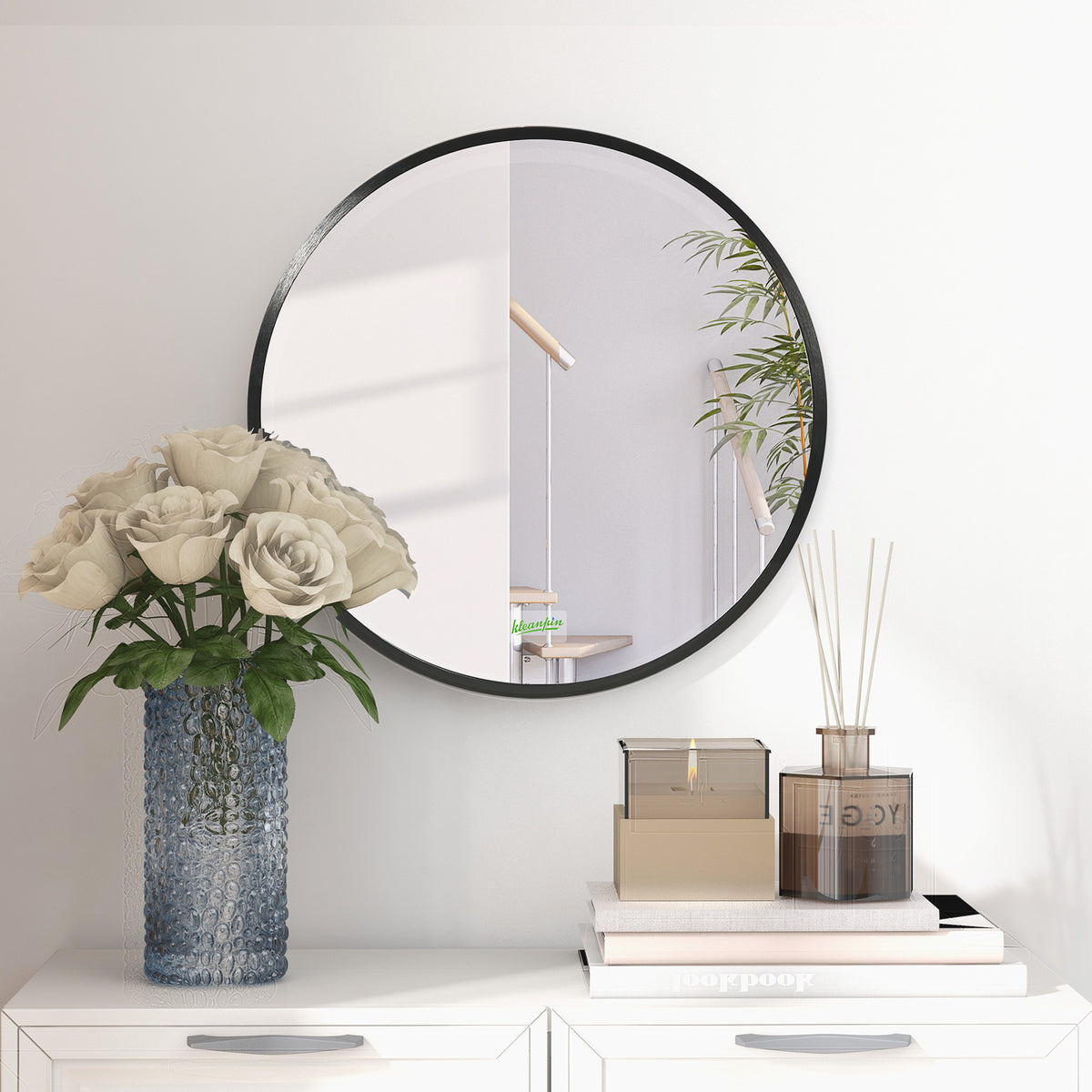 Round black-framed mirror mounted above a cabinet, shown with a partial room reflection.