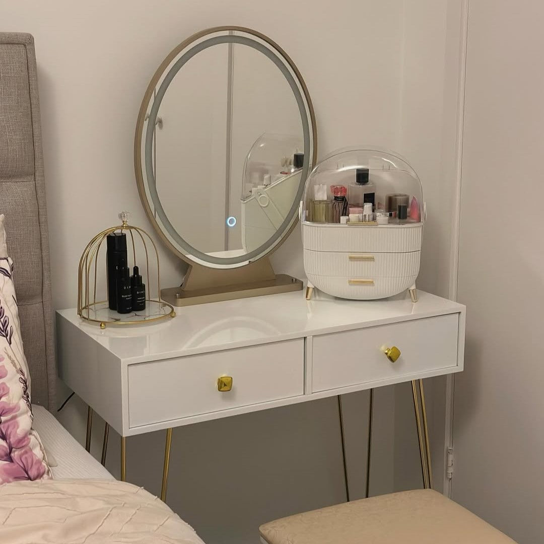 White vanity table with oval LED mirror, two drawers, and cushioned stool