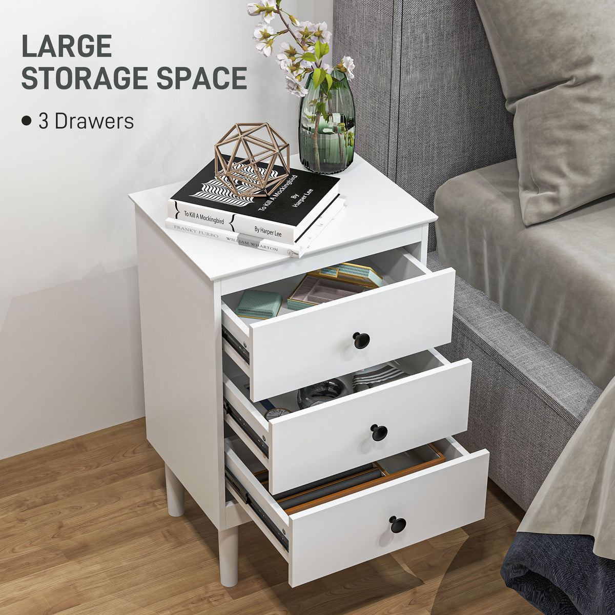 White three-drawer bedside table with drawers open to show storage space