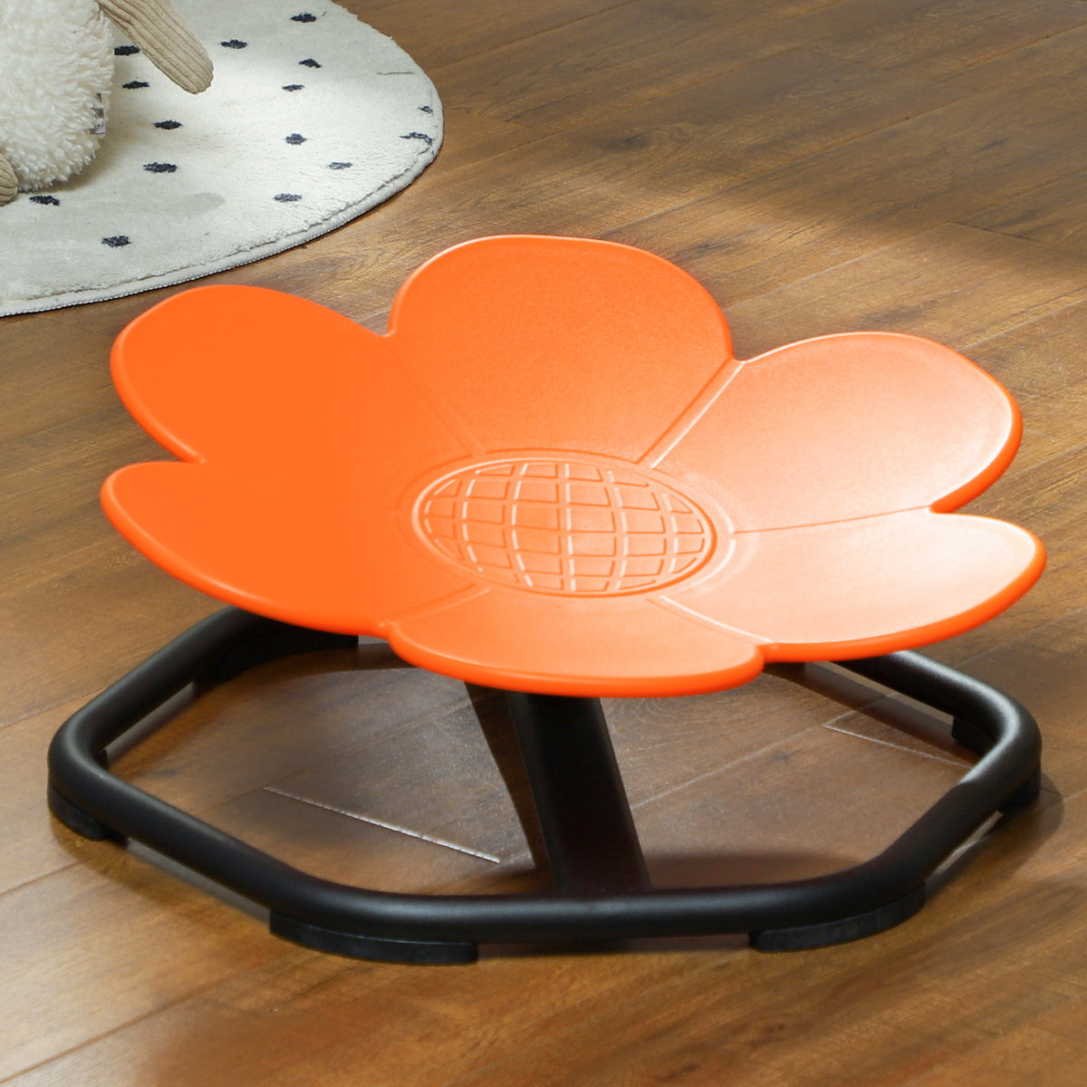 Orange flower-shaped spinning chair with textured center and black support frame