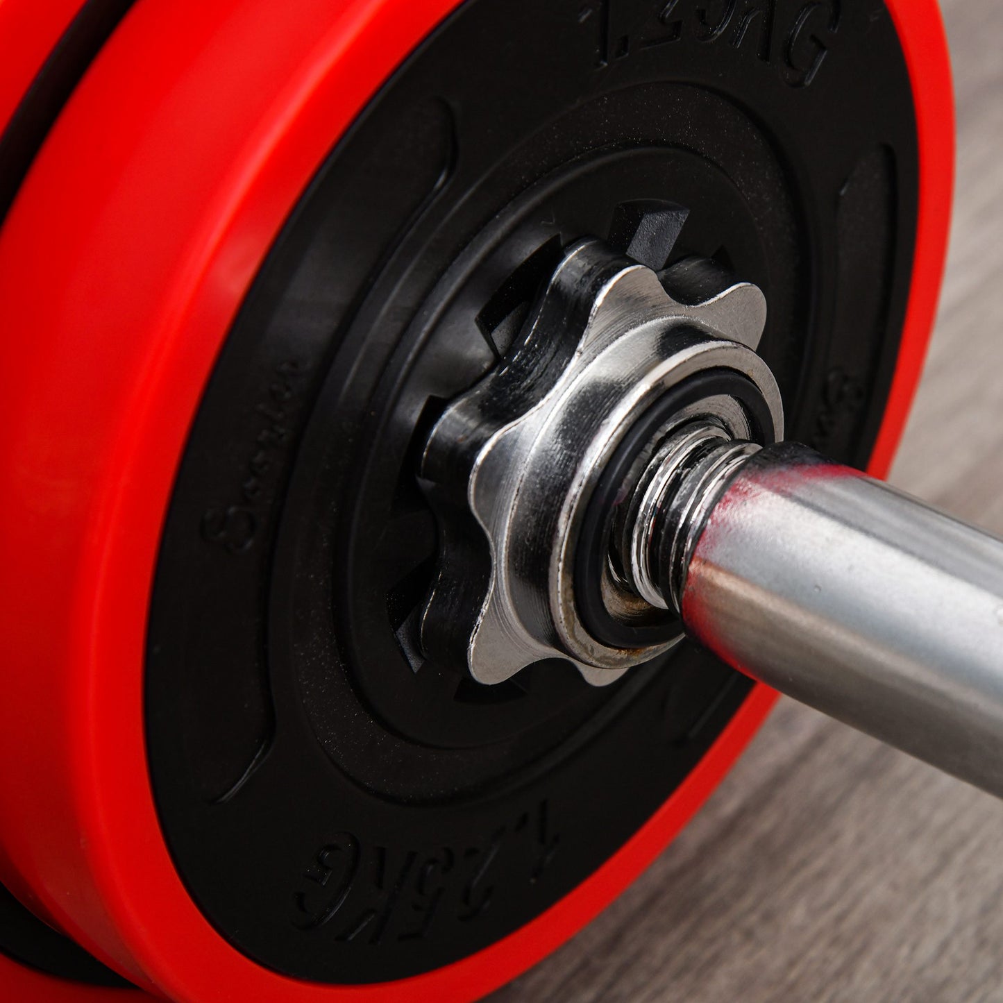 HOMCOM barbell plate secured to a metal bar with a star-shaped collar