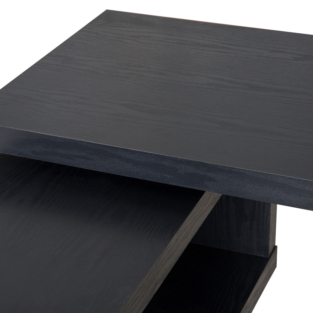 Close-up of the black wood-grain desktop and matching shelf surface.