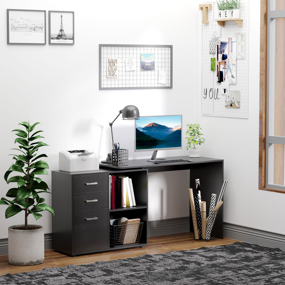 Black desk arranged as a home office with drawers and open storage