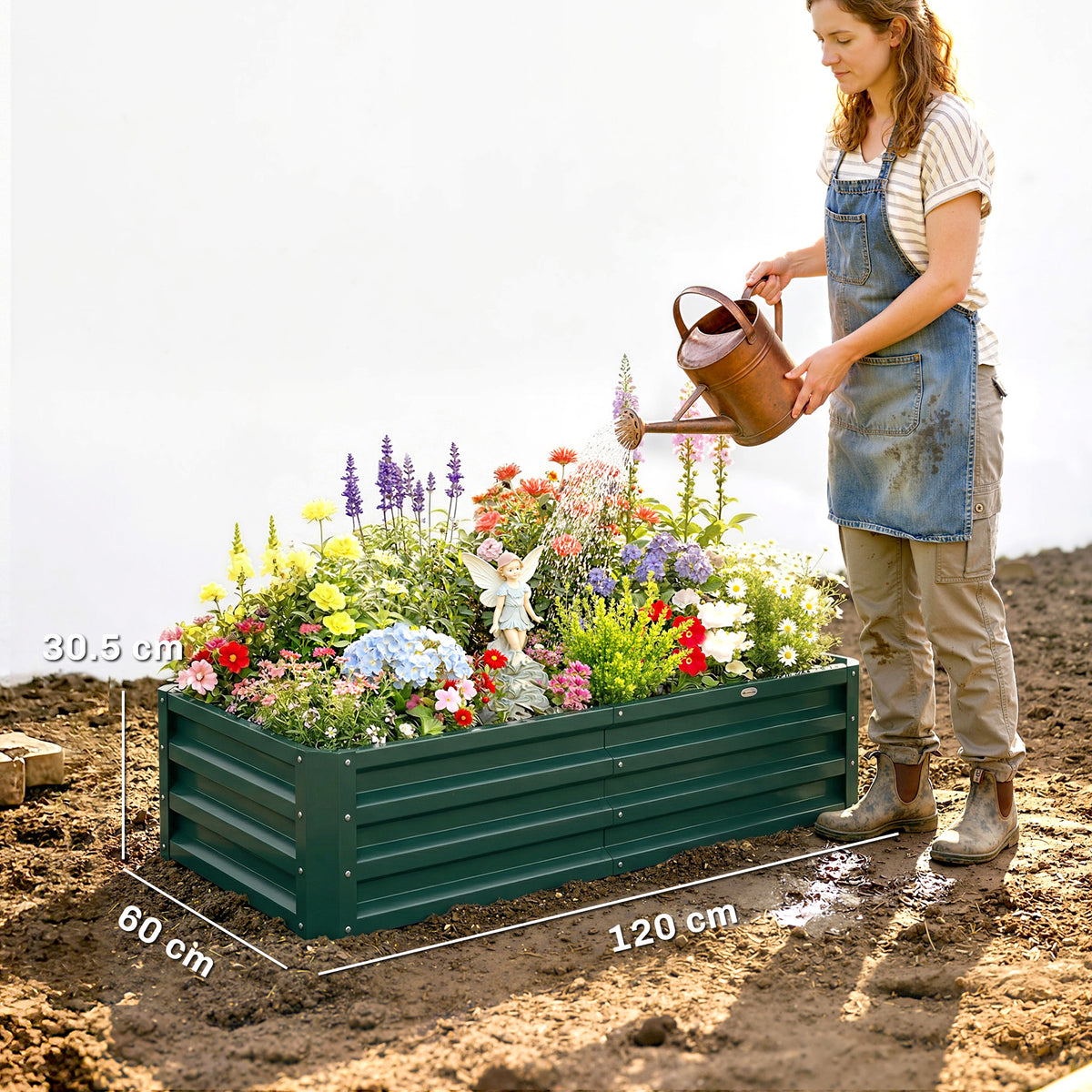 Green raised garden bed with flowers, shown beside a person for scale