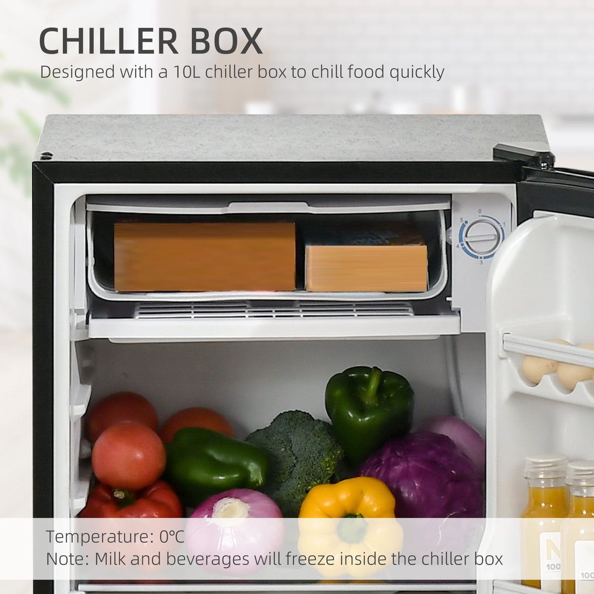 HOMCOM refrigerator interior close-up showing its top chiller box and temperature dial.
