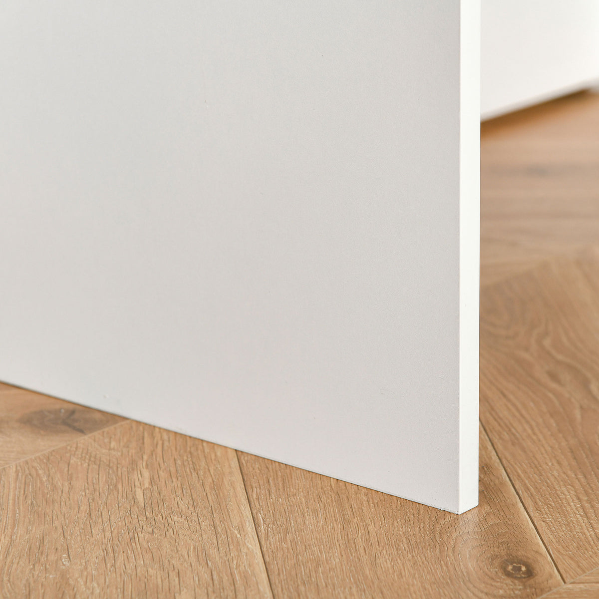 Close-up of the white desk panel edge