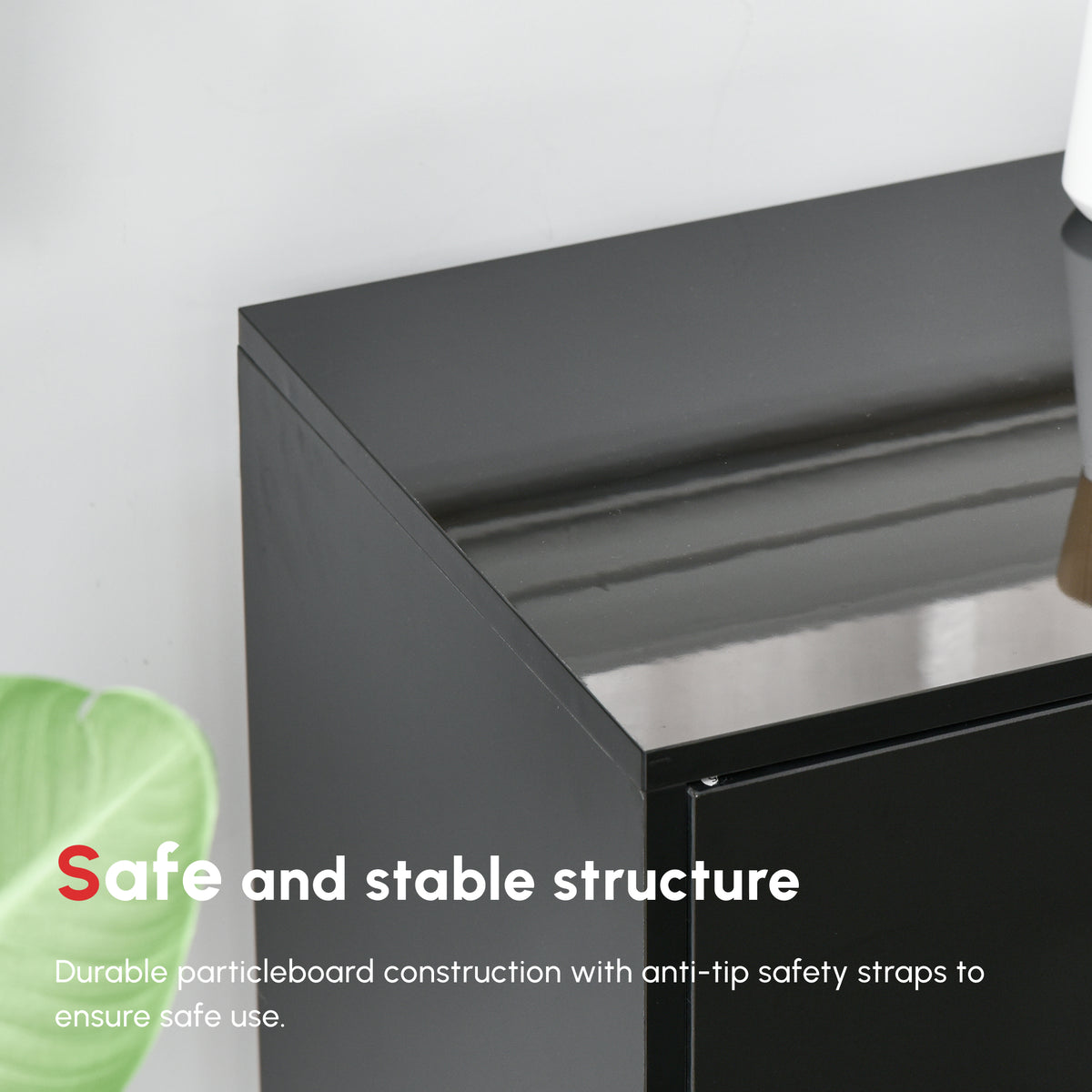 Close-up of the black side cabinet's glossy top and sturdy side panel