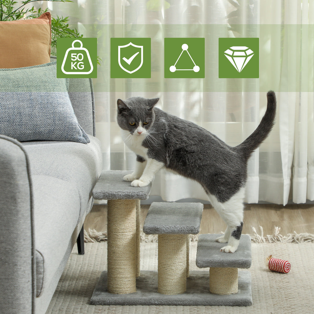 Three-step gray pet stairs with sisal posts, shown beside a sofa as a cat climbs.