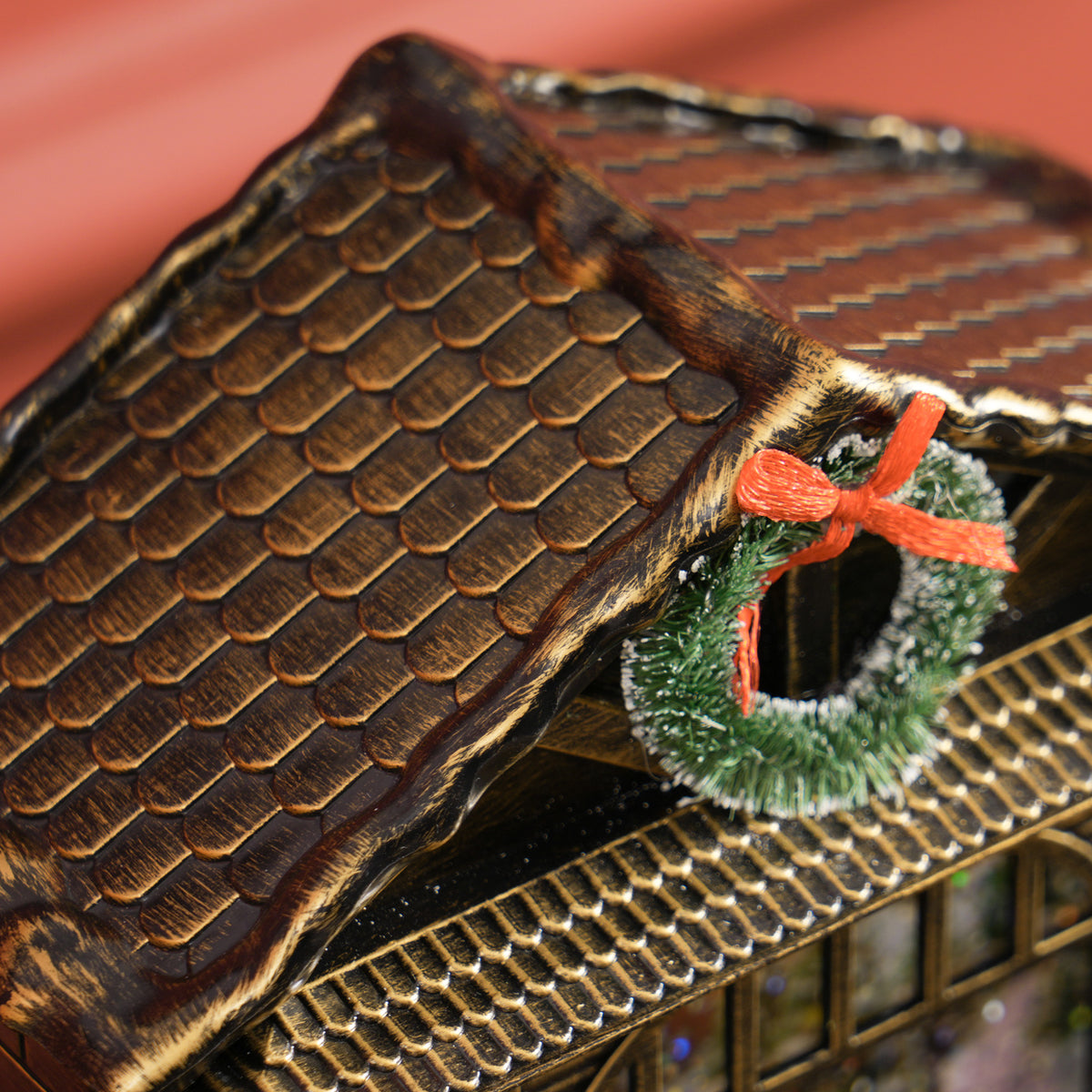 Close-up of lantern roof shingles and green wreath with red bow