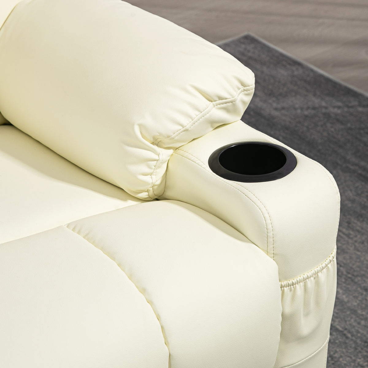 Close-up of the recliner's padded arm and black cup holder