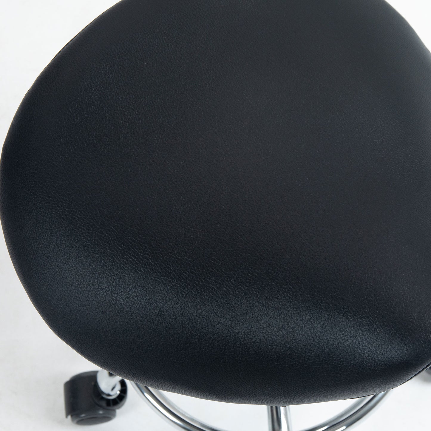 Close-up of the black textured PU leather upholstery on the HOMCOM saddle stool seat