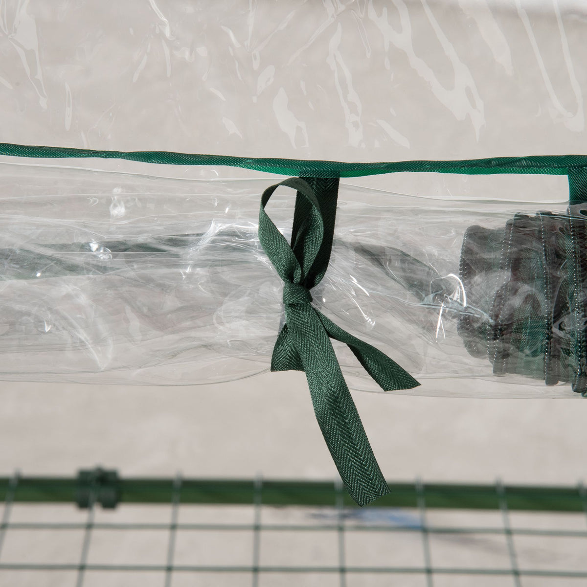 Outsunny greenhouse clear cover tied back with a green fabric strap