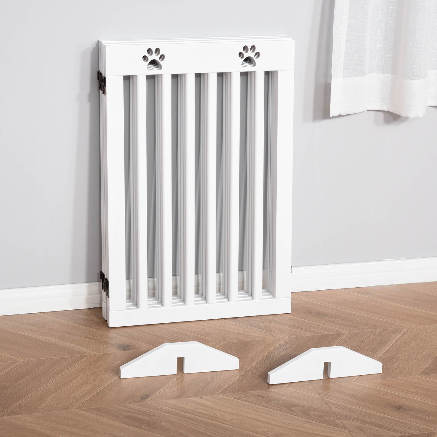 Folded white pet gate with two removable support feet