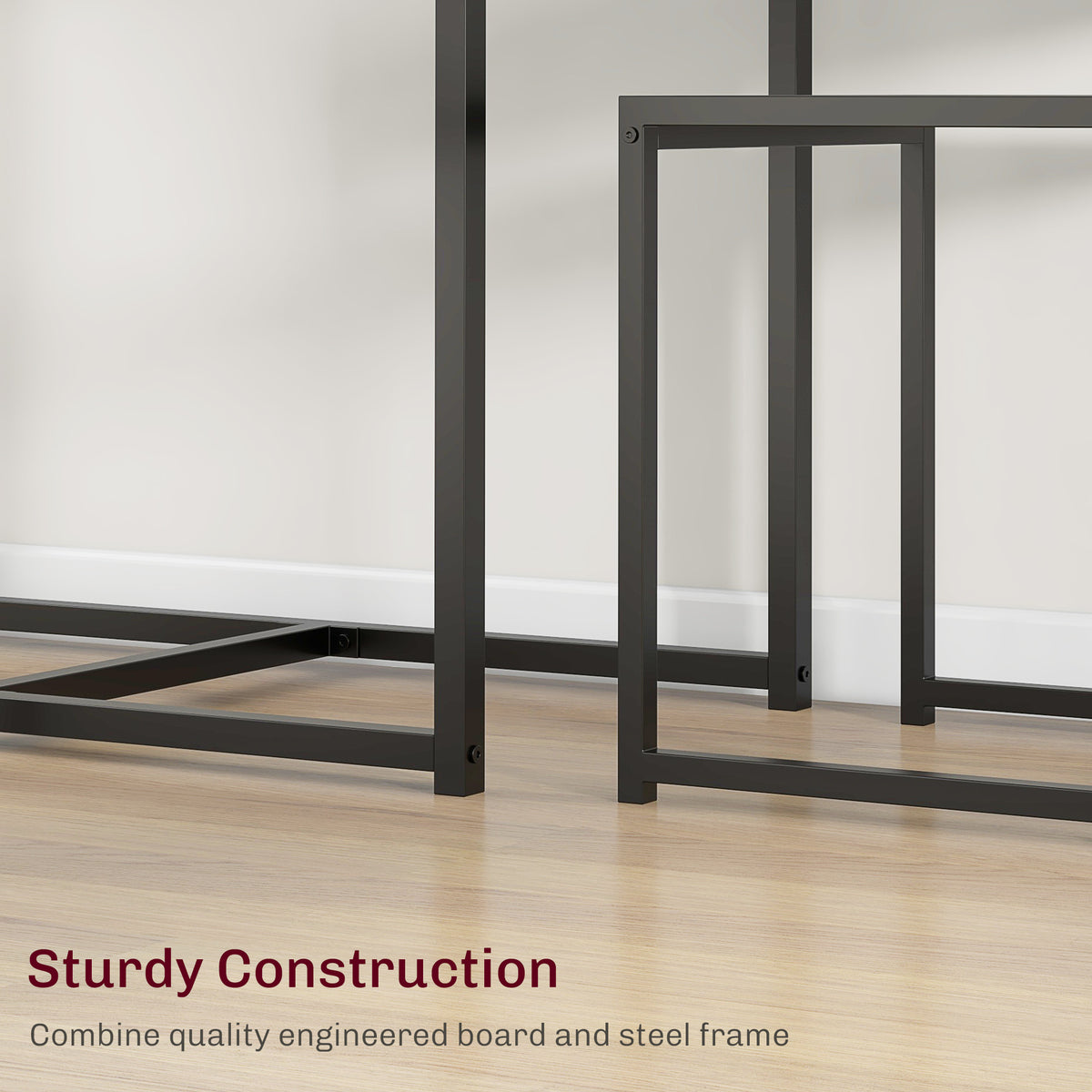 Close-up of black steel table and chair frames with crossbars and engineered wood tops
