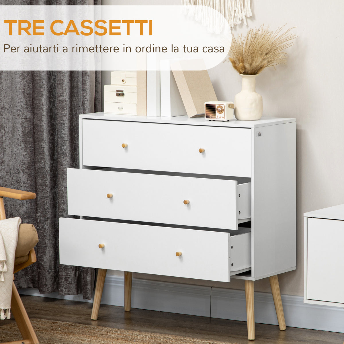 White three-drawer chest with wood legs and round wood knobs, shown with drawers open