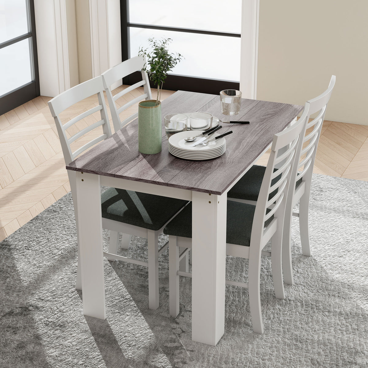 Gray wood-effect dining table with white legs, surrounded by four chairs