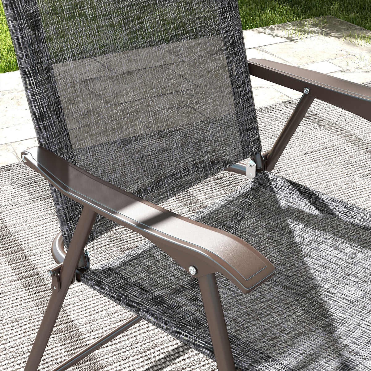 Close-up of a folding chair's gray mesh fabric and brown armrest