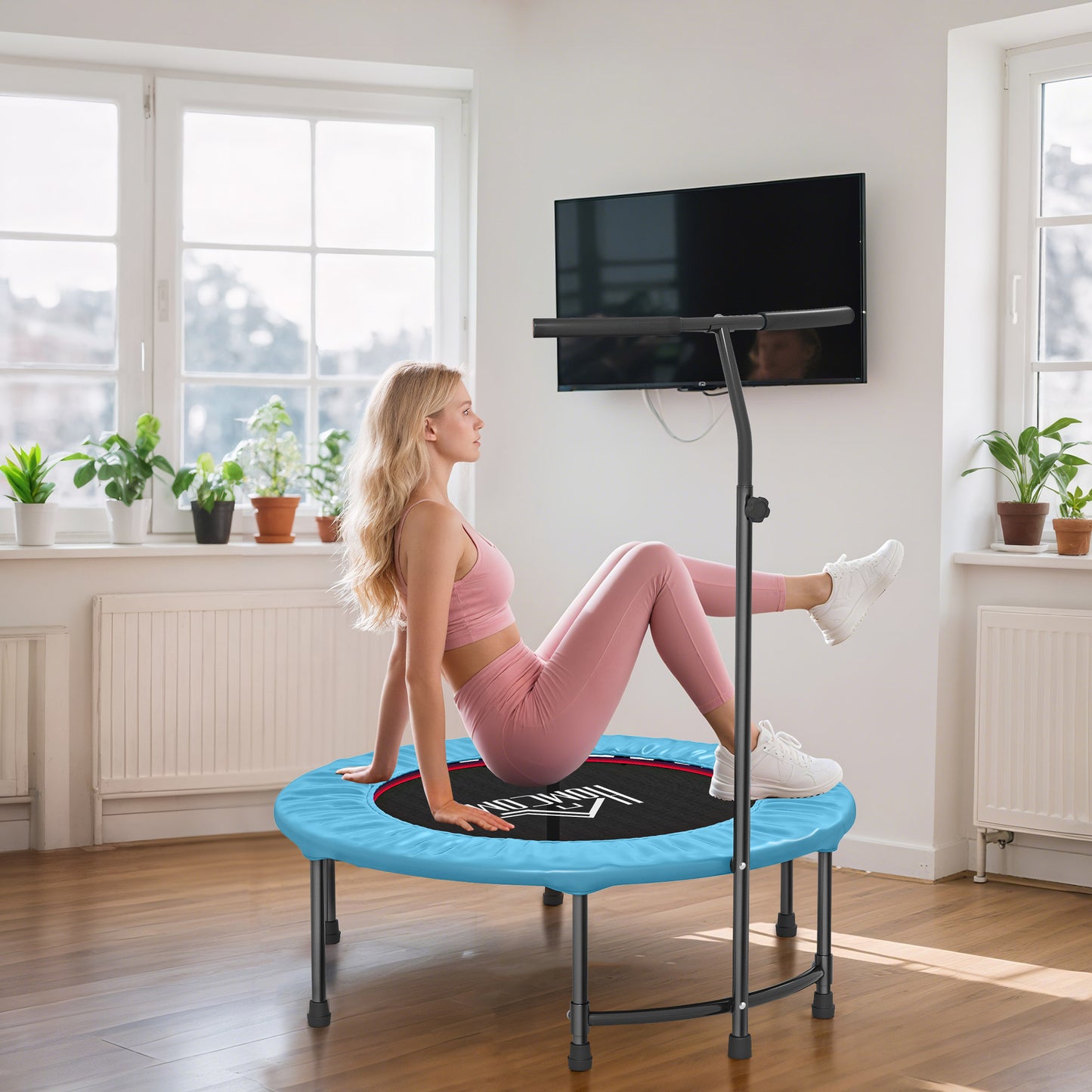 Blue fitness trampoline with handlebar and black jumping mat, shown in use