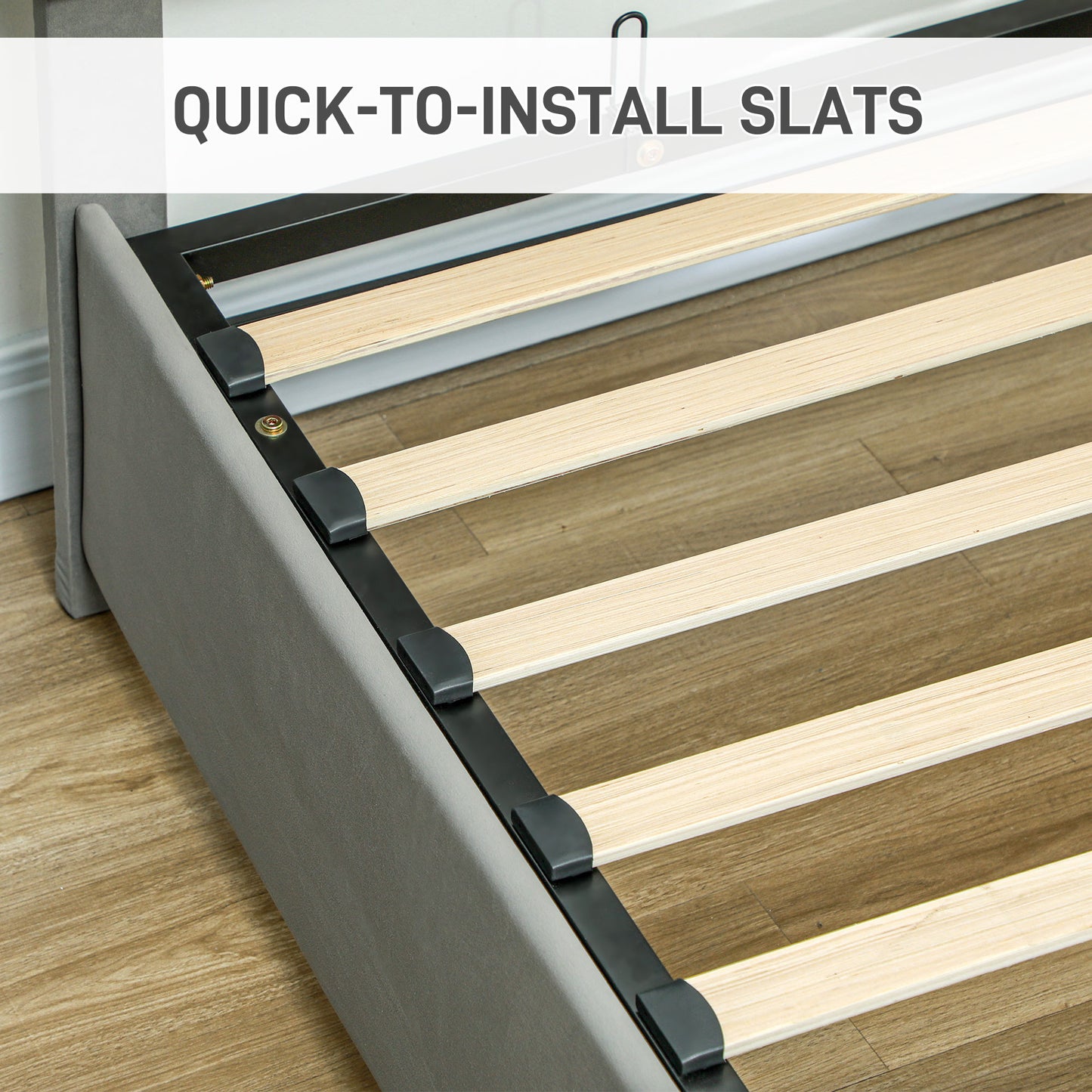 Close-up of pale wooden slats fitted into a gray upholstered bed frame