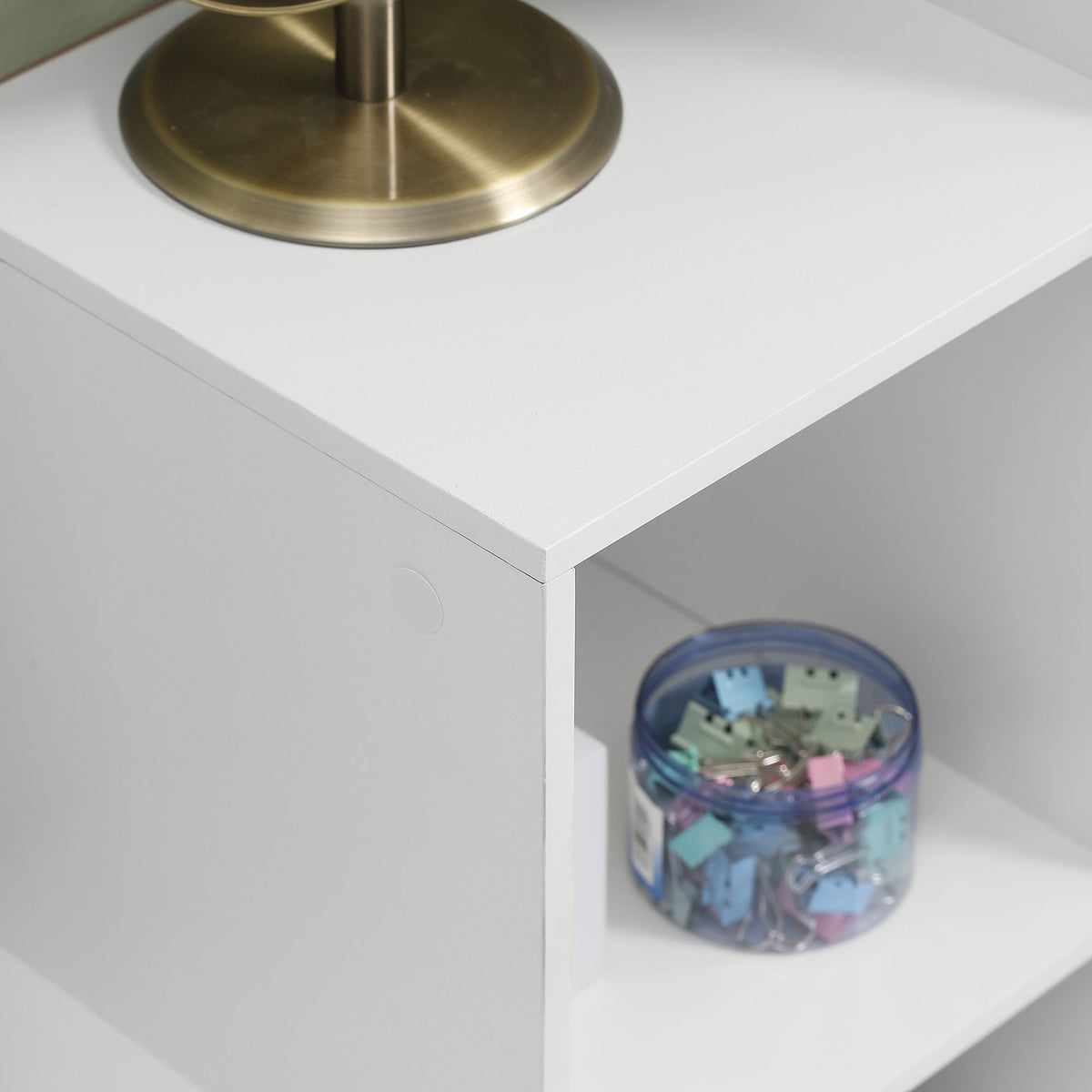Close-up of a white bookcase cube and smooth particleboard edges