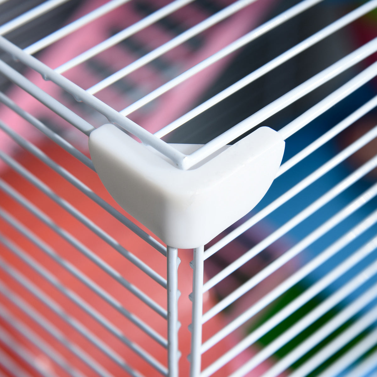 PawHut hamster cage close-up of a white corner connector joining metal bars.