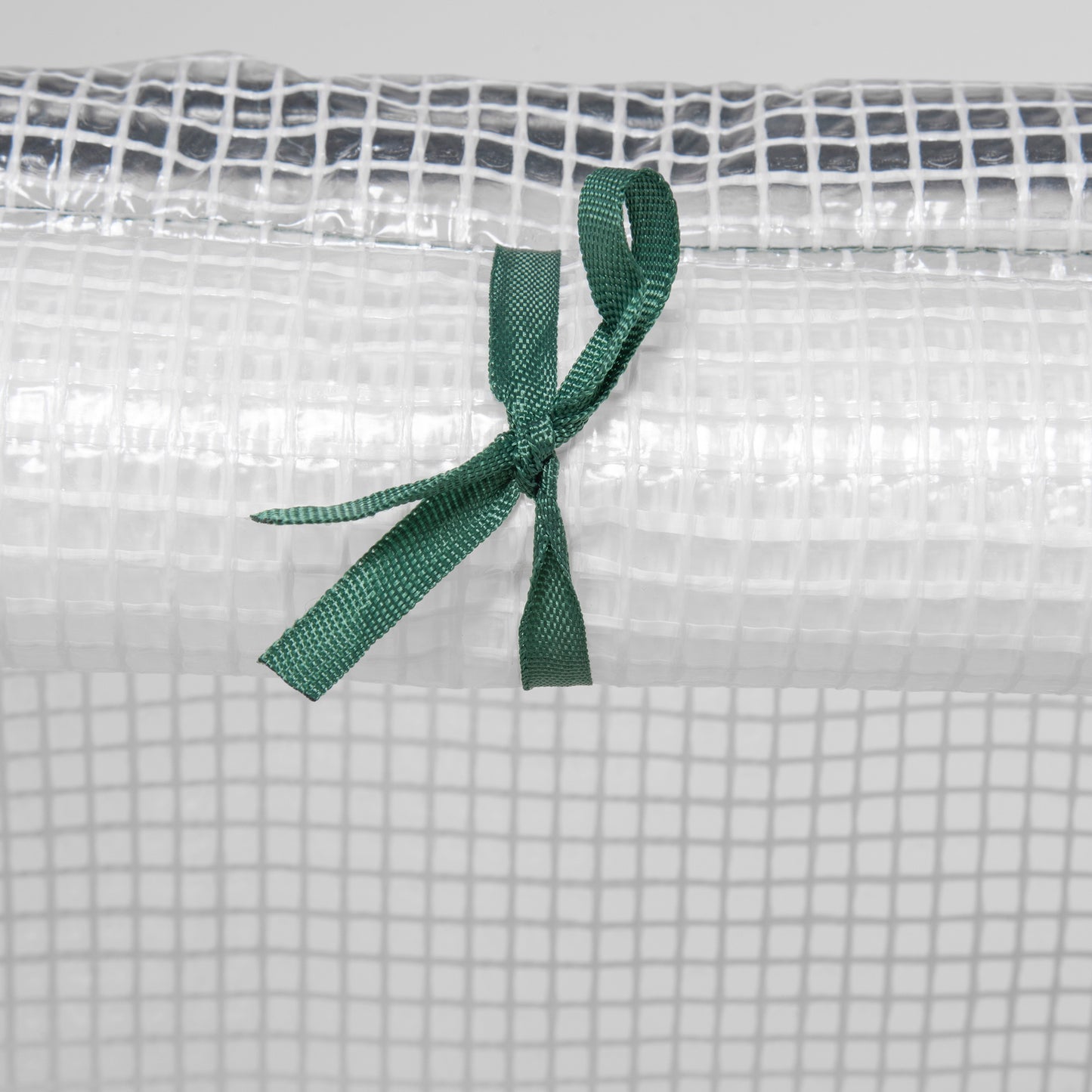 Close-up of green tie securing the PE greenhouse cover