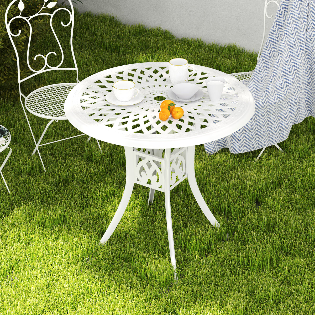 White round cast aluminium patio table with an ornate openwork top
