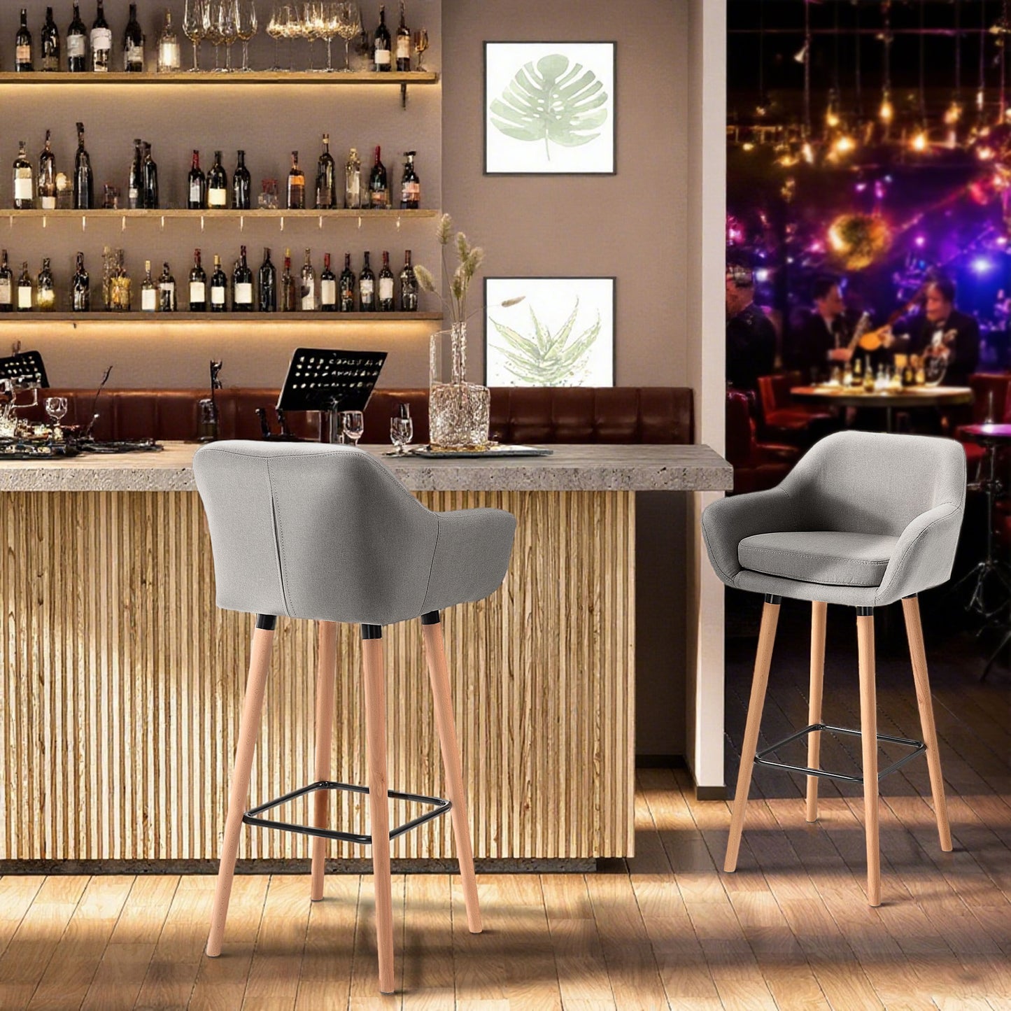 Pair of gray upholstered bar stools with wood legs and black footrests