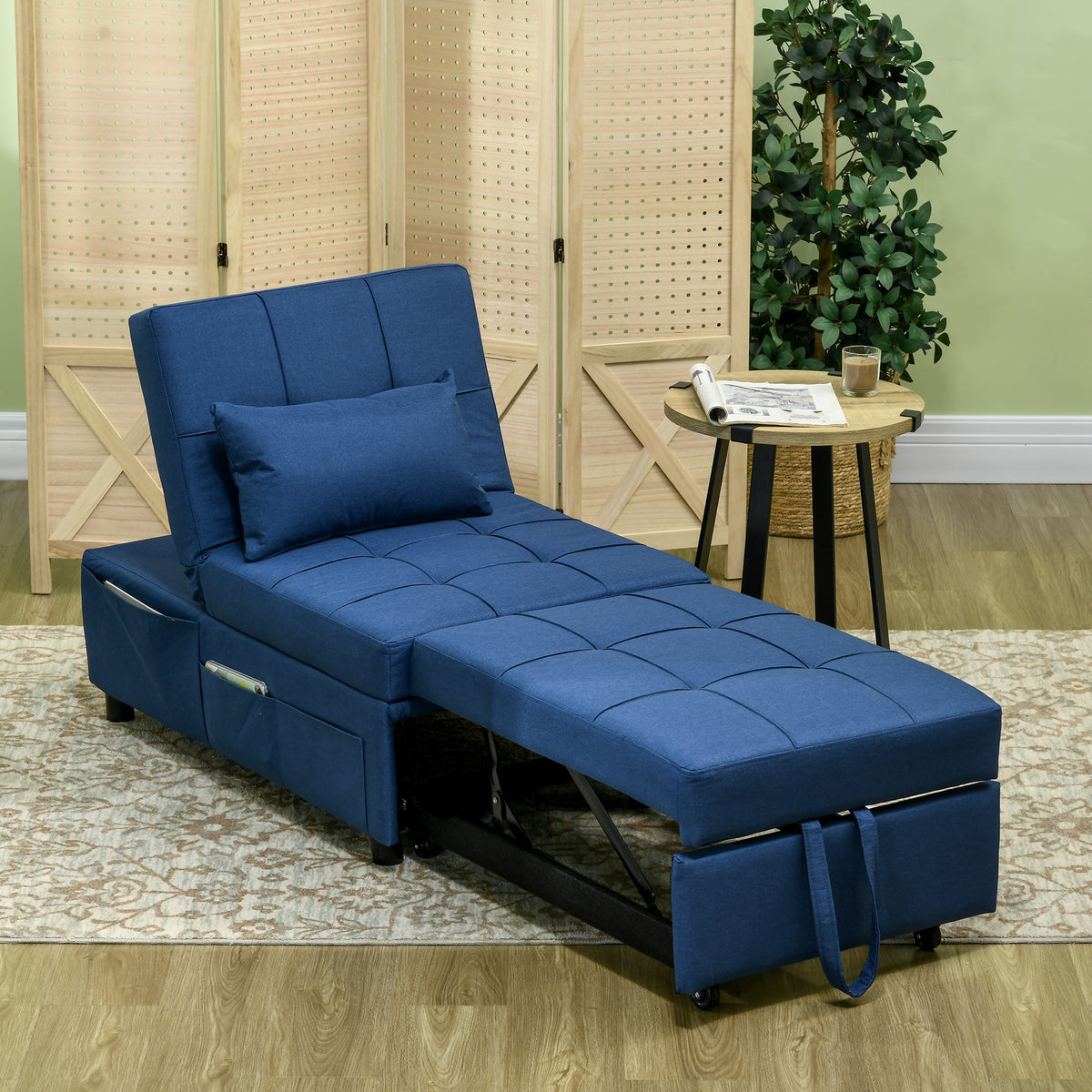 Blue chair bed extended into a padded sleeper with a matching pillow and side pocket.